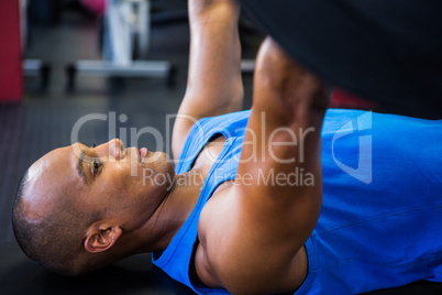 Male athlete exercising with barbell