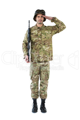 Portrait of soldier holding a rifle and saluting