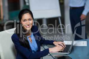 Portrait of businesswoman working on laptop