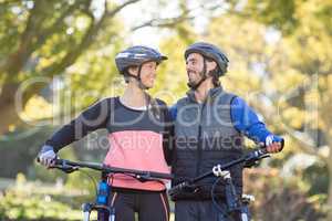 Biker couple standing with mountain bike
