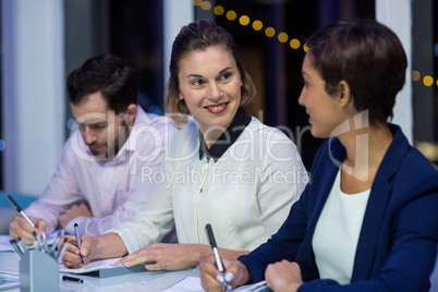 Businesswomen interacting with each other in office