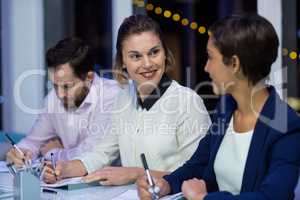 Businesswomen interacting with each other in office