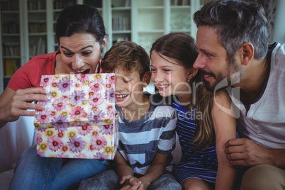 Family opening the surprise gift  in living room