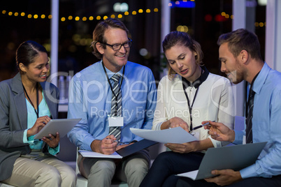 Businesswoman discussing with colleagues over document