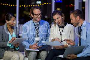 Businesswoman discussing with colleagues over document