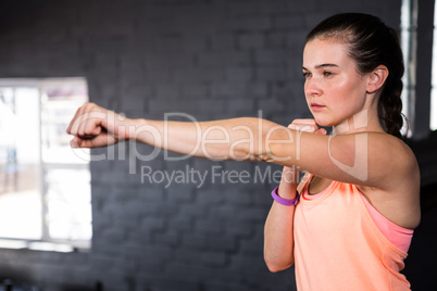 Young woman punching in gym