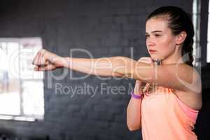 Young woman punching in gym