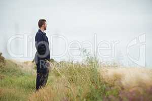 Thoughtful farmer standing in field
