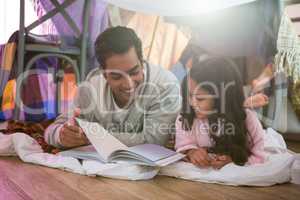 Father and daughter reading book