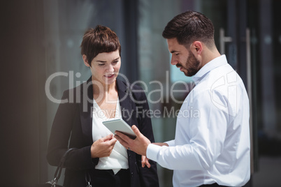 Businesspeople using digital tablet