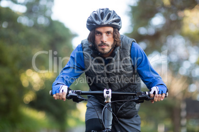 Male biker cycling in countryside