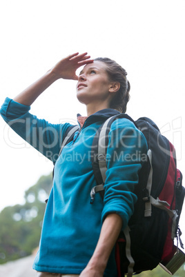 Female hiker shielding her eyes
