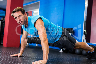 Portrait of serious athlete doing push-ups