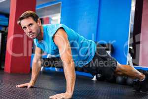 Portrait of serious athlete doing push-ups