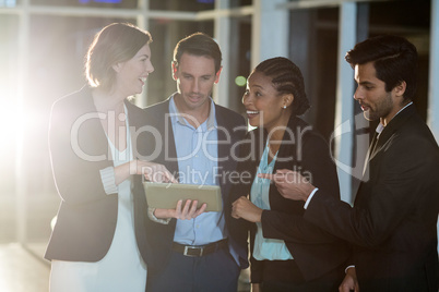 Group of businesspeople discussing together over digital tablet Group of businesspeople discussing together over digital tablet