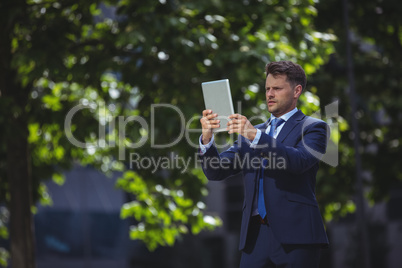 Handsome businessman using digital tablet