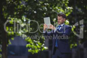 Handsome businessman using digital tablet