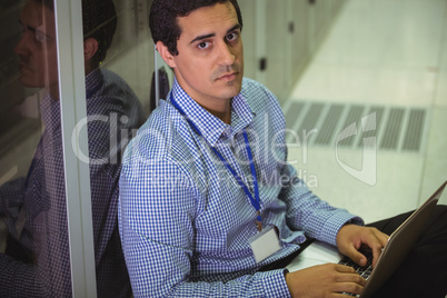 Portrait of technician using laptop