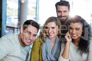 Smiling friends posing in cafÃ?Â©