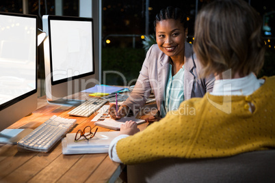 Businesswoman interacting with colleague