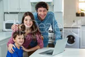 Portrait of family with laptop