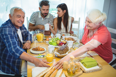 Couple having breakfast with their parents