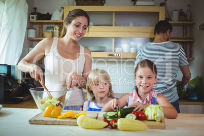 Mother and daughter preparing salad in the kitchen