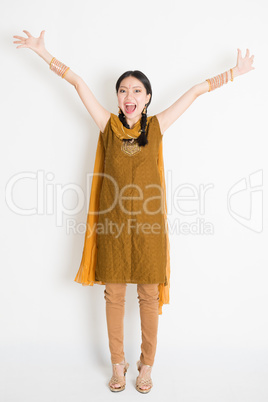 Excited Indian Chinese woman arms raised