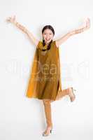 Excited Indian Chinese female arms raised