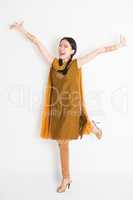 Excited Indian Chinese girl arms raised