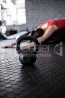 Female athlete exercising by kettlebell