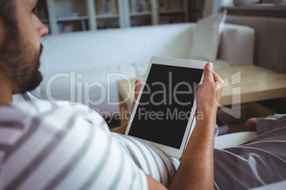 Man using digital tablet in living room