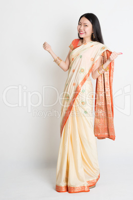 Woman in Indian sari dress thumbs up