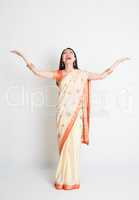 Woman in Indian sari dress hand raised looking up