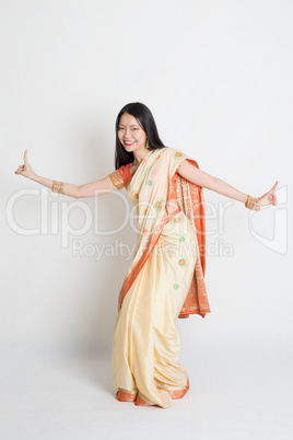 Female in Indian sari dress dancing