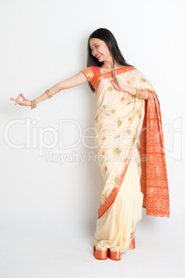 Woman in Indian sari dress dancing