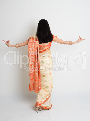 Rear view female in Indian sari dress dancing