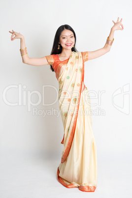 Girl in Indian sari dress dancing