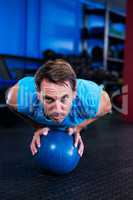 Portrait of serious athlete with ball in gym