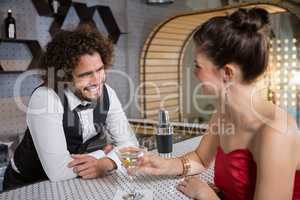 Waiter interacting with beautiful woman