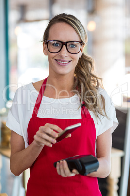Woman scanning mobile phone with NFC technology