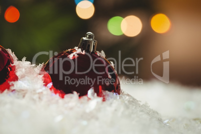 Close-up of christmas baubles on snow