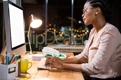 Businesswoman working on computer at her desk