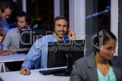 Businessman with headsets using computer in office
