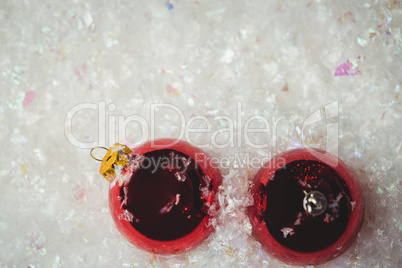 Close-up of christmas baubles on snow