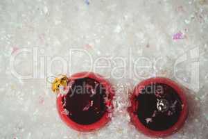 Close-up of christmas baubles on snow