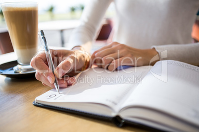 Woman writing in diary