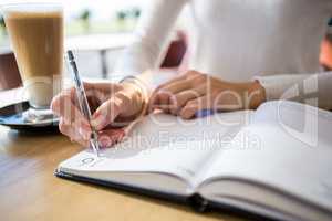 Woman writing in diary