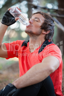 Male mountain biker drinking water