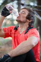 Male mountain biker drinking water